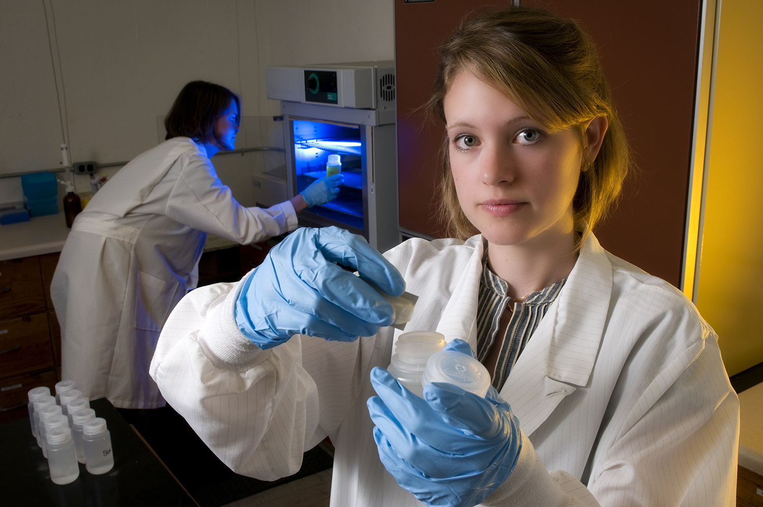 Student holding water sample bottles in the Biological Systems Engineering Water Quality Laboratory