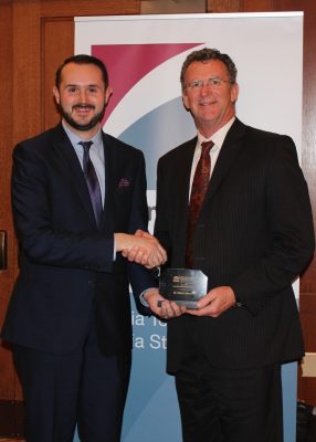 Brad Copenhaver, at left, presents Edwin J. Jones, at right, with the 2015 Land-Grant University award last month.