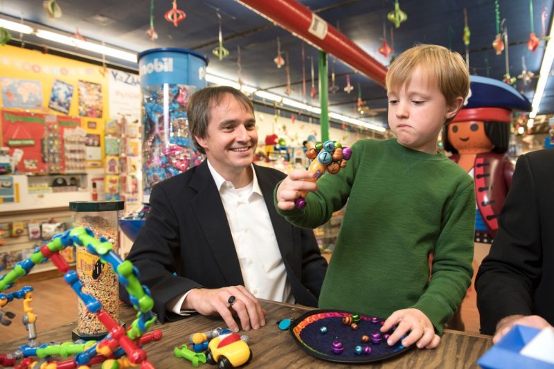 Virginia Tech toy safety researcher Rich Gruss watches as a local child discovers a new toy at the Imaginations store in Blacksburg.