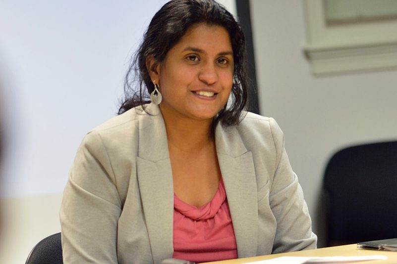 Shalini Misra at desk in classroom