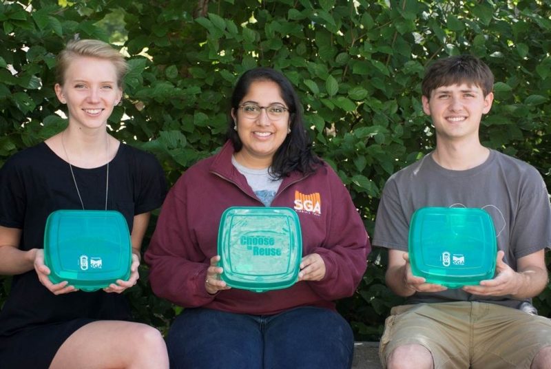 Amelia Smith, 2014-15 Student Government Association Sustainability Co-Chair; Tanushri Shankar, 2015-16 Student Government Association president; and Amory Fischer, 2014-15 Office of Sustainability intern hold Reusable To-Go containers.