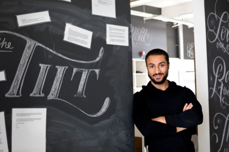 Khaled Hussein, co-founder of Tilt, with Tilt sign