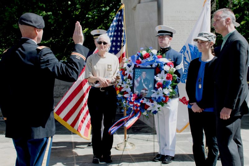 Col. Kevin Milton, at left, posthumously commissions the late Joseph DeWitt as a second lieutenant with DeWitt’s family in attendance at the Pylons. 