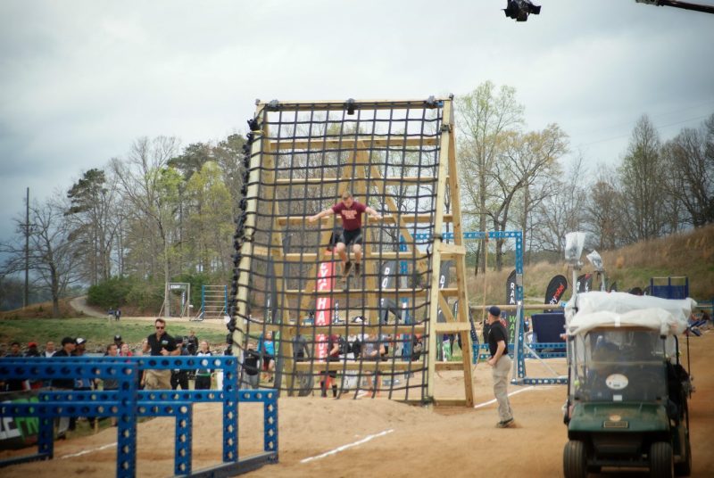 A team member jumps from a 20-foot obstacle during the competition