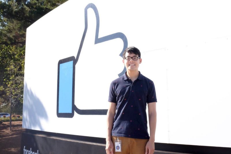 Michael Liu stands in front of the Facebook logo at the company's headquarters in Menlo Park, California.