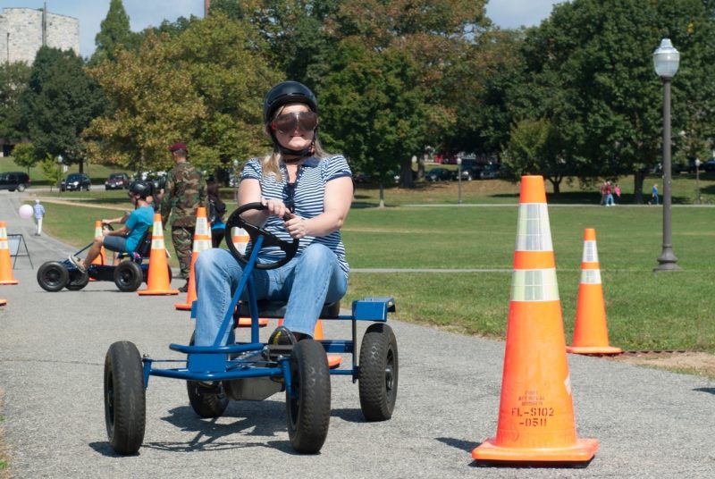 A participant uses a Drunk Goggle Cart during Virginia Tech Community Day.