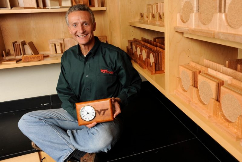 D. Earl Kline holding a clock set in a wooden base
