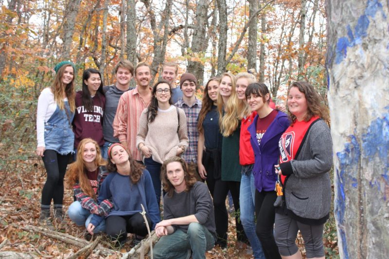 Member of the Virginia Student Environmental Coalition at Virginia Tech in forest with blued trees.