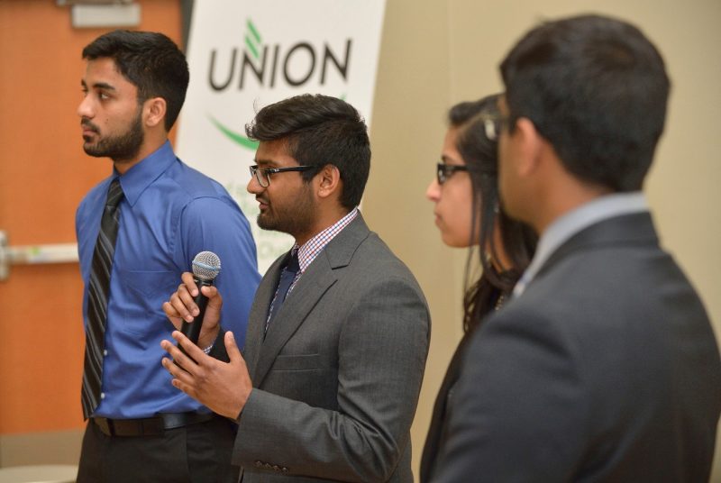 Four students pitch their team idea to judges in the Union Innovation Challenge of 2016.