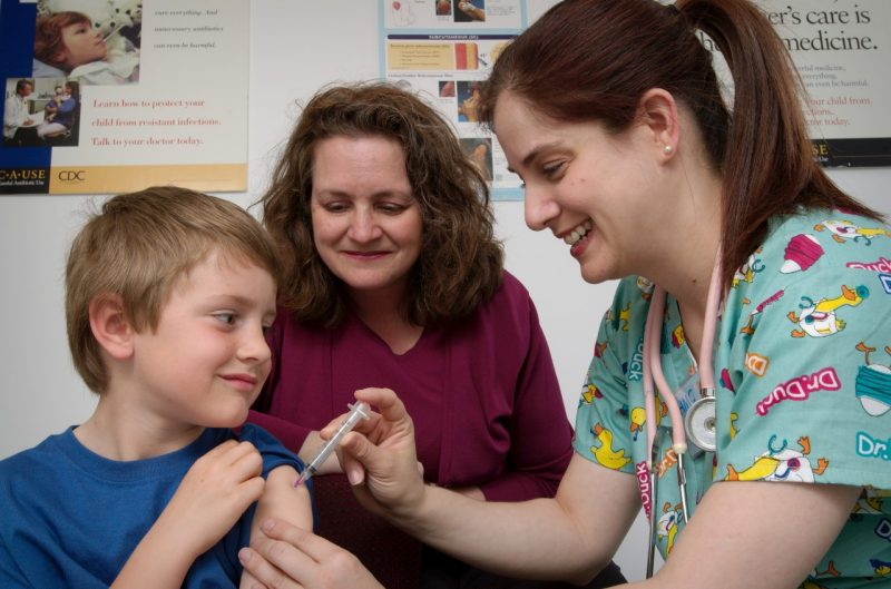 A nurse administers an intramuscular vaccination to a young boy with his mother looking on. It's not too late to get an influenza vaccine, said Virginia Tech Carilion's Thomas M. Kerkering. Photo courtesy Centers for Disease Control and Prevention. 