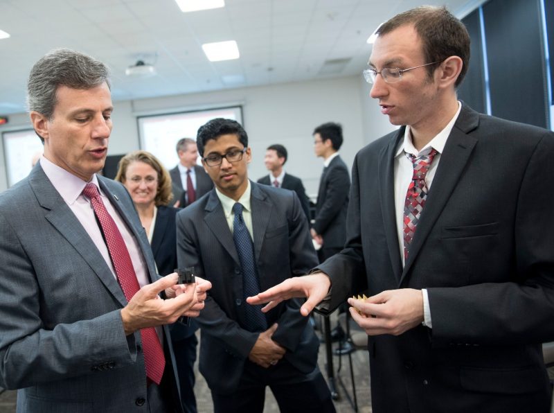 Zachary Newhart (electrical engineering ’17) describes a 3-D printed transformer case held by Mauro Atalla (engineering mechanics, Ph.D. ’96), UTC Aerospace Systems vice president of engineering technology, sensors, and integrated systems, during a visit by executives from the company to Virginia Tech.