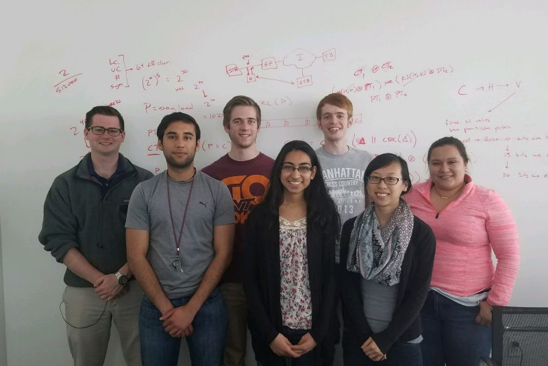 Standing in a group are students in the first CyberLeaders program cohort from left to right: Nicholas Cohen, Milan Bhatia, Thomas Fowler, Neha Kapur, Sam Jones, Keily Shay,  Zilmara Bonnet