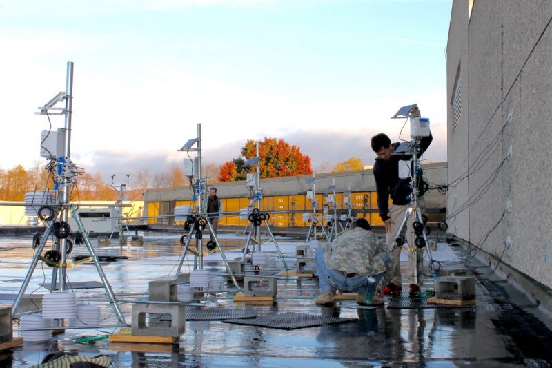Students setting up rooftop sensors.