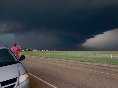 Captured from the van as the storm chase crew races to keep up, a large tornado churns across the western South Dakota countryside.