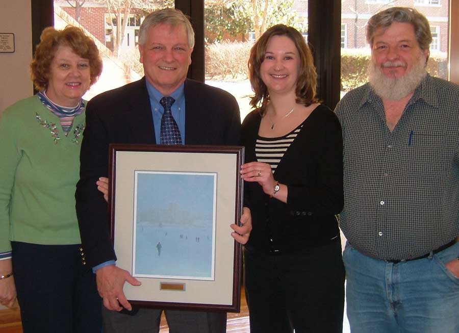 Dean Jerry Niles holds framed Tuckwiller print