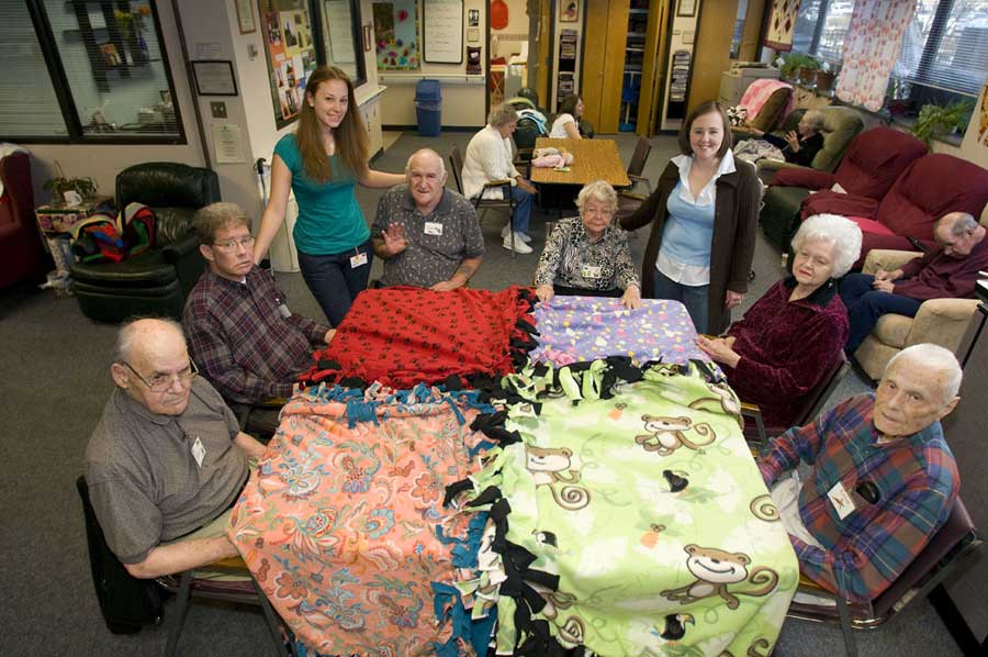 A Caring Hands member works to make a blanket.