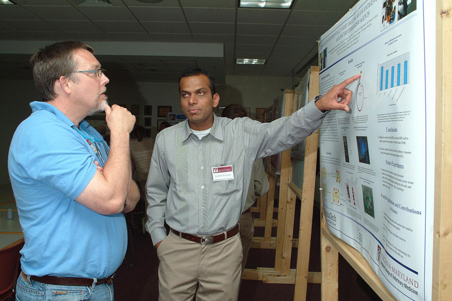 Chris Roberts (left), an associate professor of virology in the Department of Biomedical Sciences and Pathobiology, and Parthiban Rajasekaran, a biomedical sciences and pathobiology Ph.D. student.