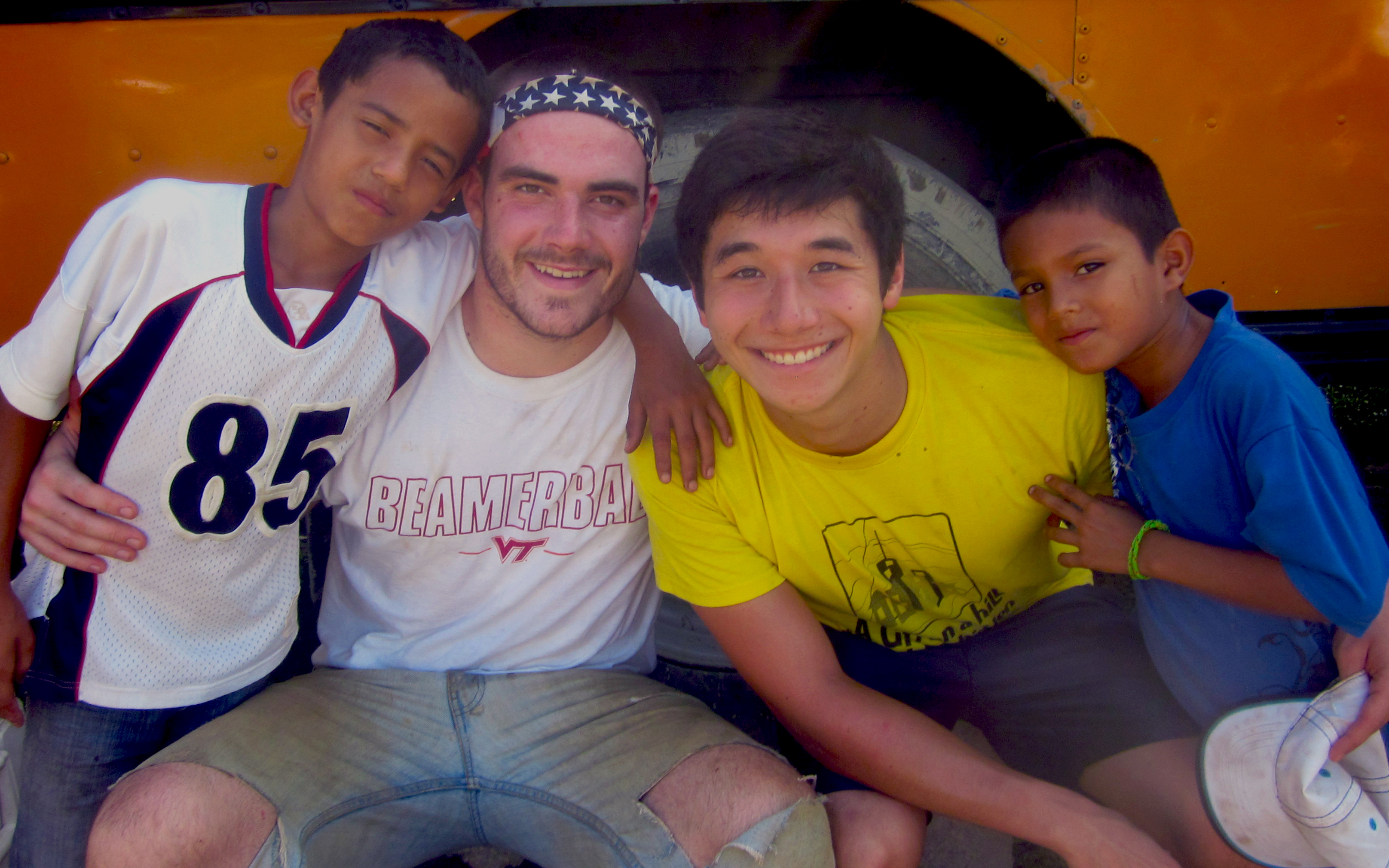 John Duffy (second from left) and Josh Enokida (third from left) pose with two Honduran boys.