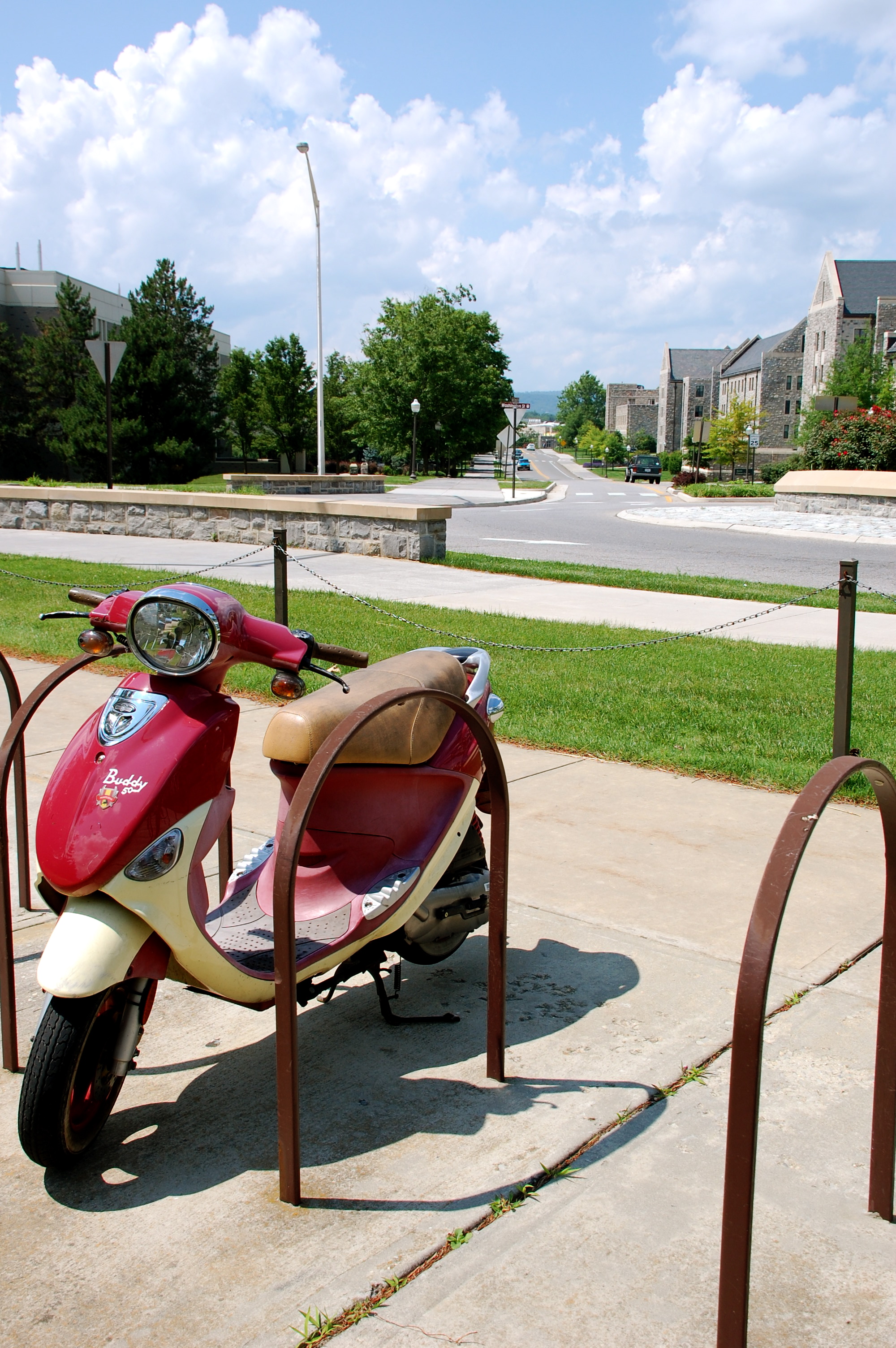 A moped parked in front of McComas Hall.