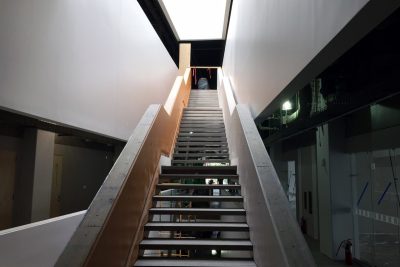 An open staircase within the building, with a skylight above, bringing natural light into the building.