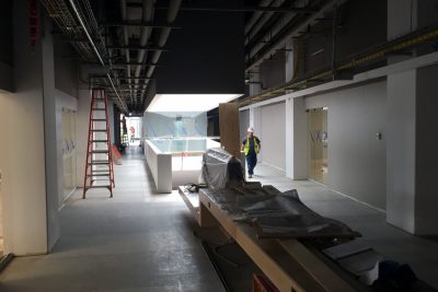 Light pours in from the skylight above the staircase. The building is being constructed to LEED certification standards.