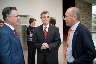 Virginia Tech President Tim Sands (left), Vice President for Advancement Charles Phlegar (center) and David Calhoun talk. 