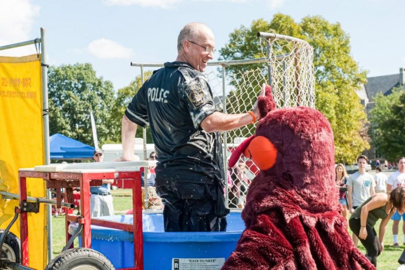 John Tarter of the Virginia Tech Police Department with the Hokie Bird after being dunked in the dunk tank