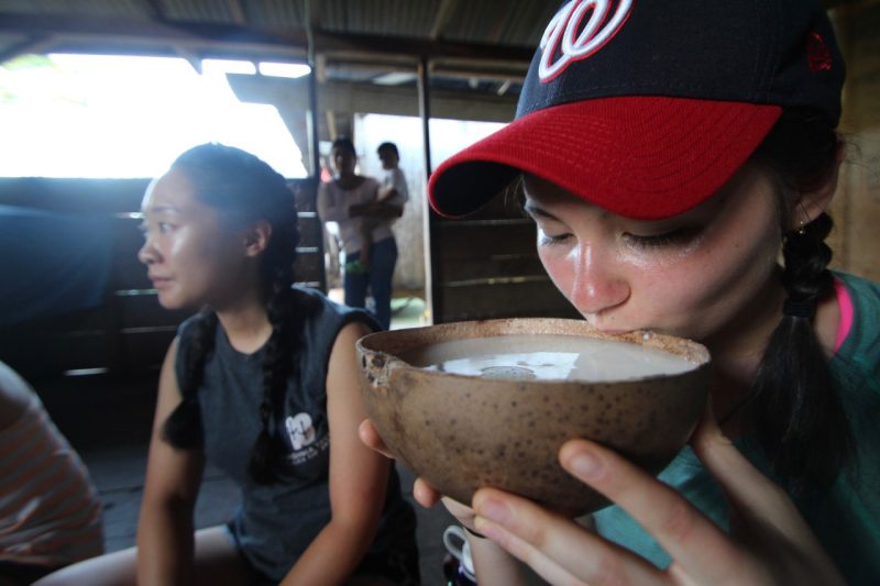 Chloe Rogers samples chicha, a traditional fermented drink..
