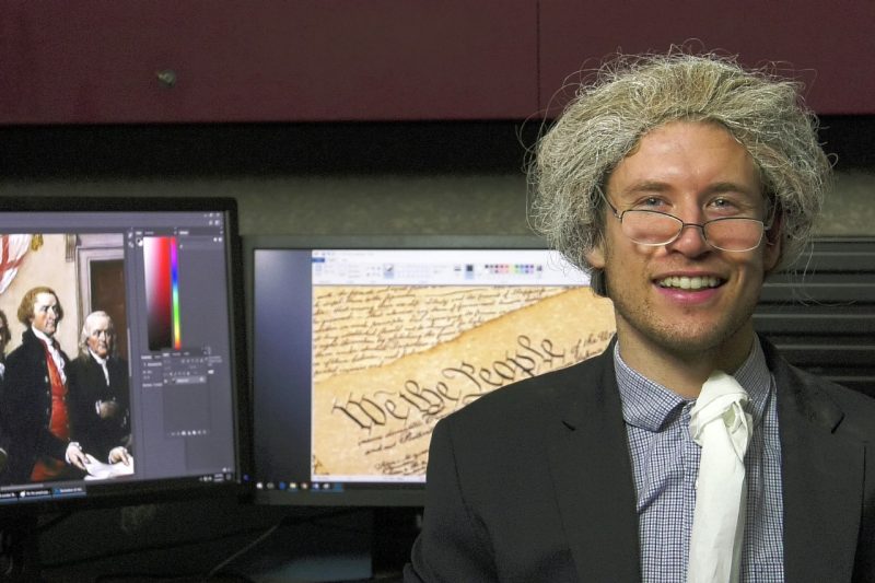 Maxwell Vandervliet in costume with partial screenshot of Founding Fathers