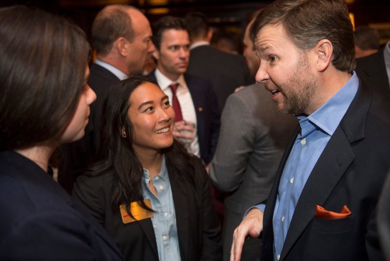 Two students from the Apex Systems Center for Innovation and Entrepreneurship chat with a Virginia Tech alumnus at a reception in New York City..