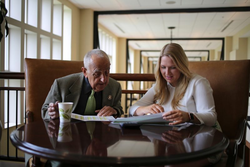 Howard Feiertag (left), who mentored many students,  works on a project with Allison Toupin, who graduated in 2017 and now works as a revenue manager at Marriott's corporate headquarters in Bethesda, Maryland. 