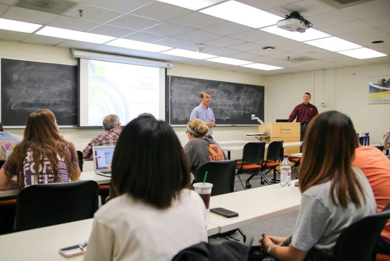Hospitality and tourism management professor Juan Luis Nicolau makes introductory remarks to a class on revenue management while guest speaker Dave Roberts, Marriott senior vice president, waits to address the students.