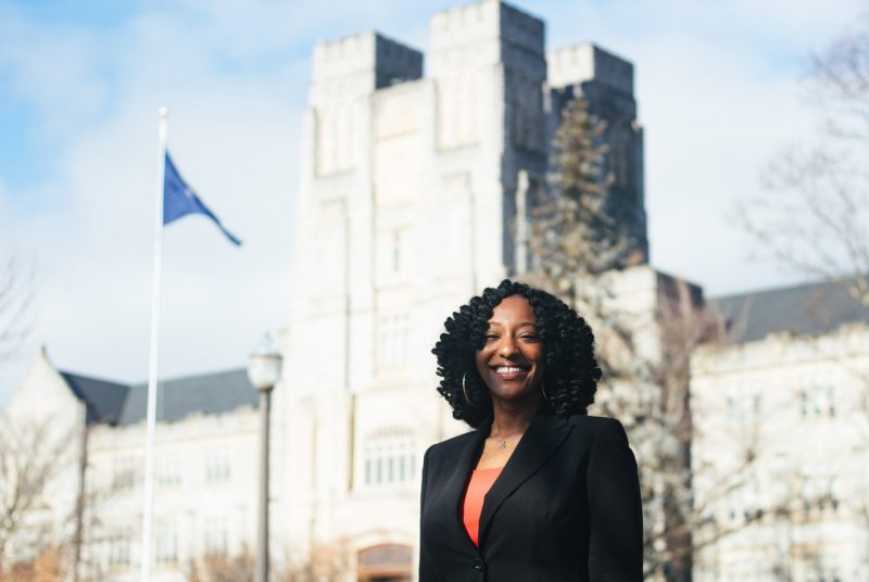 Janice Hall stands in front of Burruss Hall