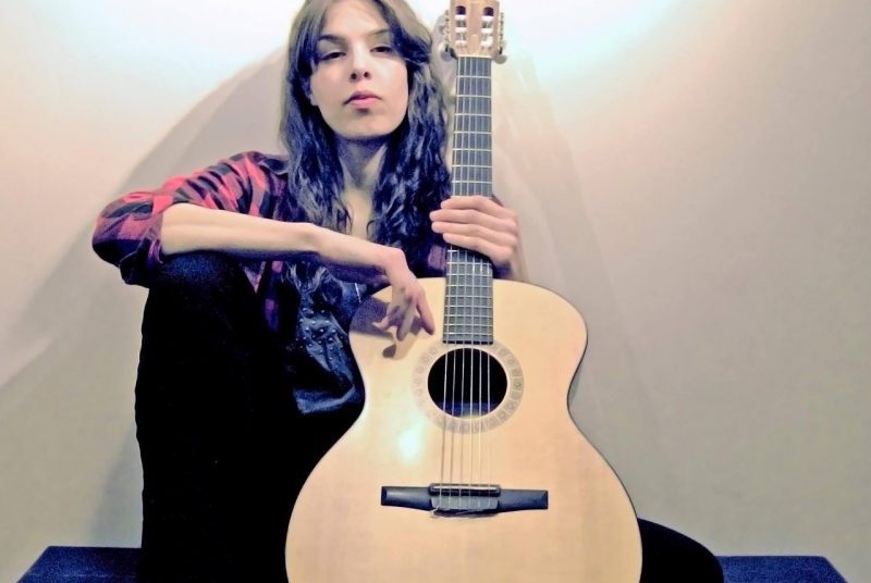 Singer/songwriter Johanna Vaughan poses with her guitar.