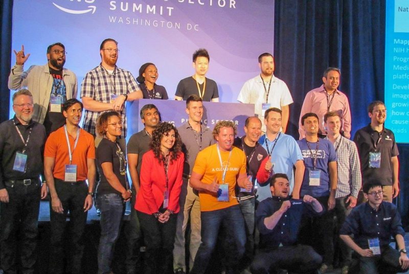 hackathon winners and judges gather on state to celebrate
