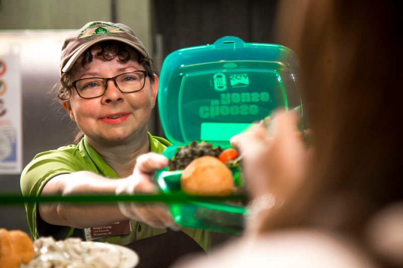 Dining Services employee serving a meal.
