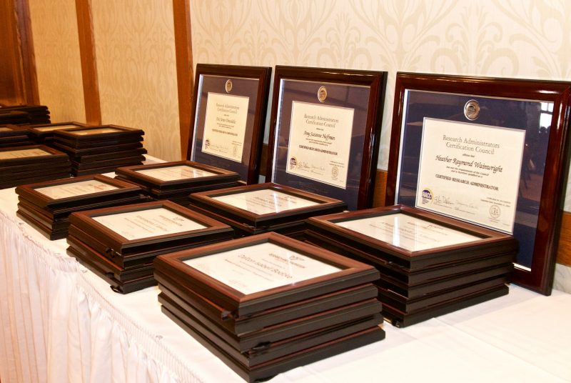 Pictured are certificates that were awarded to employees for completing professional development and research administration programs at a ceremony held on July 18.