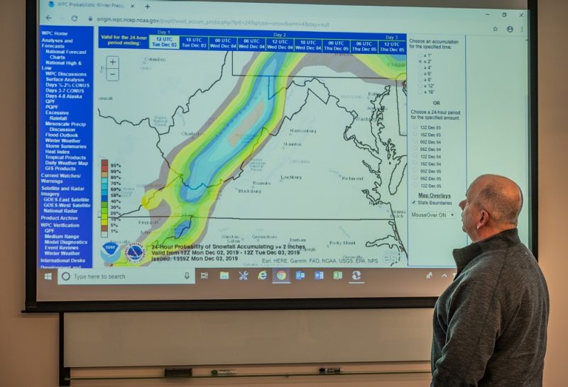 John Beach of Virginia Tech Facilities monitoring a weather map projected on a screen