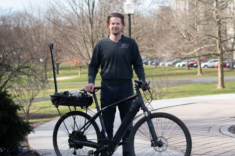 Steve Hankey standing with his instrumented bicycle 