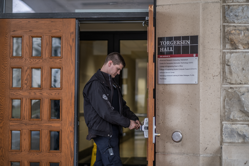 Security guard at Virginia Tech unlocks Torgersen Hall.