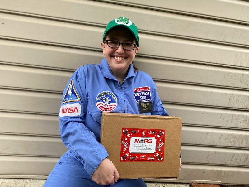 4-H Youth Development Specialist Chantel Wilson shows off one of the educational kits for the "Mission to Mars" STEM Challenge. 
