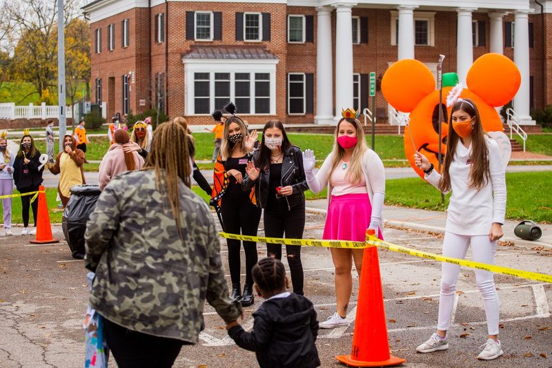 Students dress in costume to wave at community members who came to Oak Lane