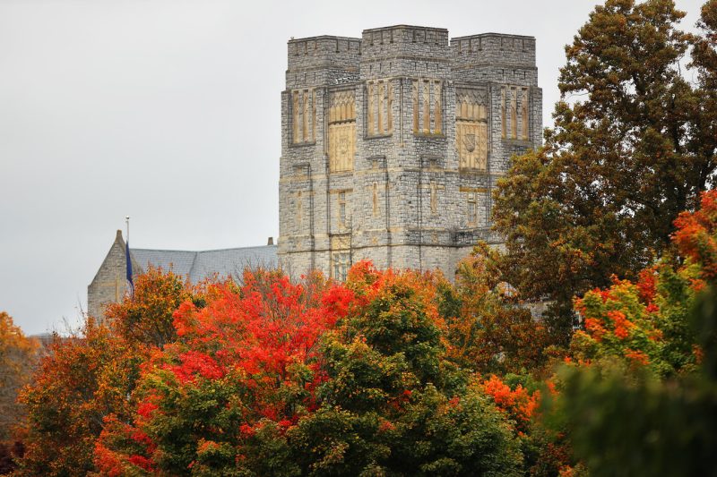 Burruss Hall in the background with fall foliage in the foreground.
