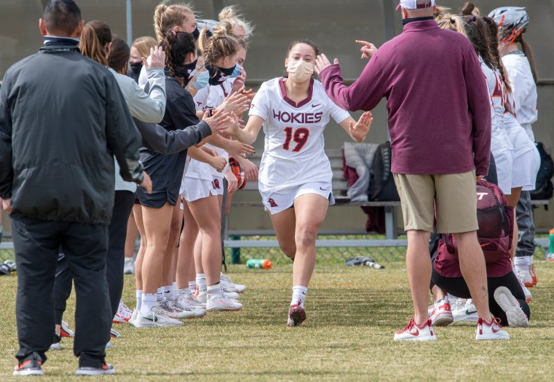 Jacelyn Lazore running onto the field before a Virginia Tech lacrosse game