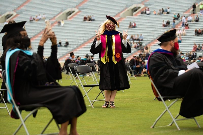 A graduating student stands to be recognized